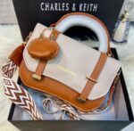 C&K branded crossbody bag for girls in soft material with stylish keychain