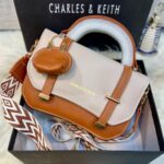C&K branded crossbody bag for girls in soft material with stylish keychain